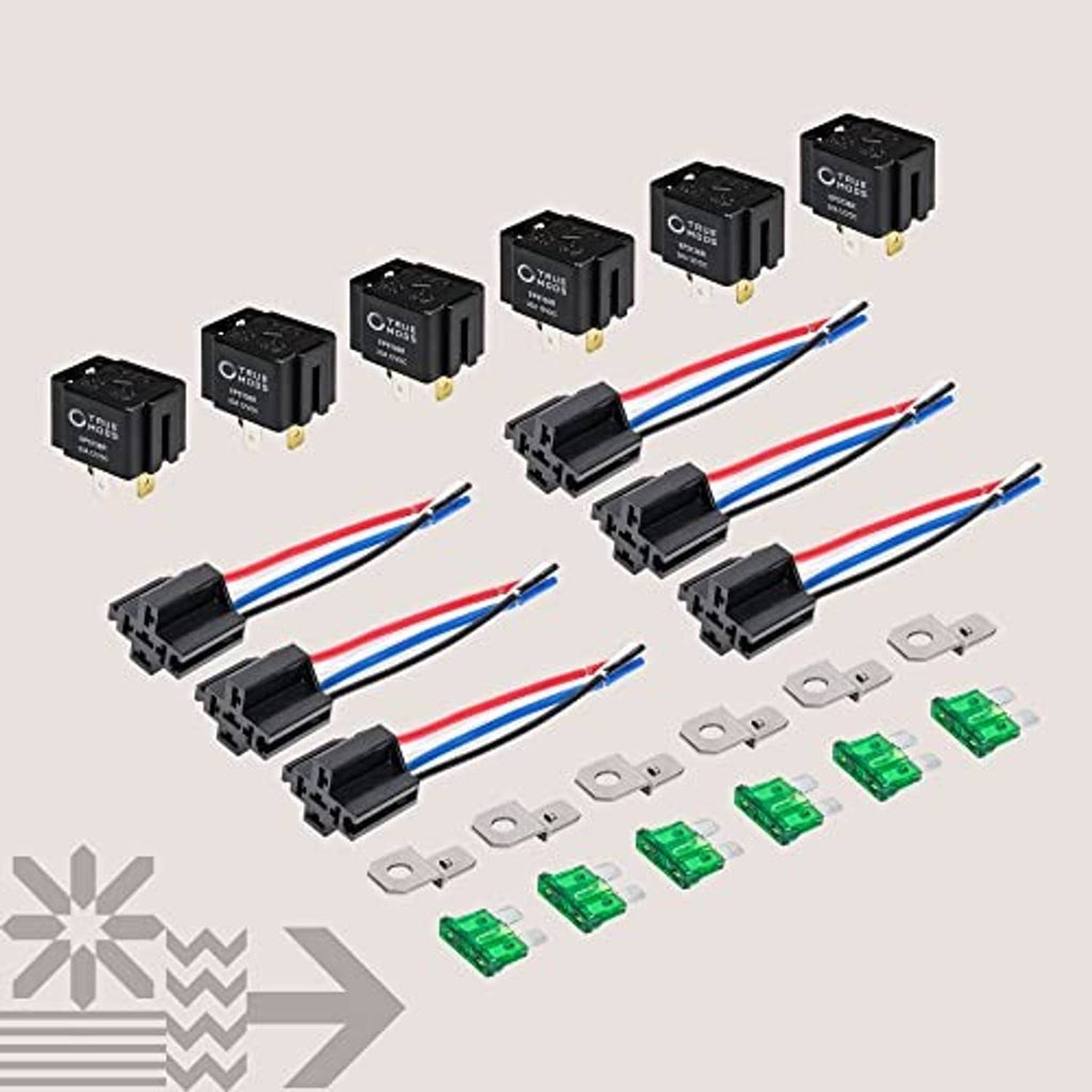 Bosch-style fused relay switch kit components with black relays, green fuses, and terminals