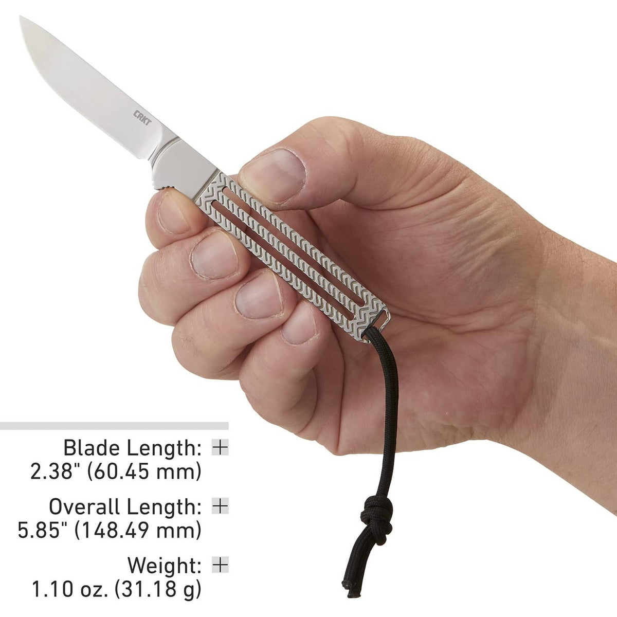 Hand holding fixed blade knife showing black-and-gray textured handle and lanyard cord