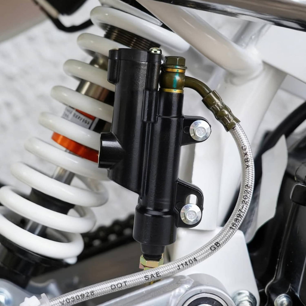 Black rear brake master cylinder mounted on ATV with hydraulic hose and metal fittings