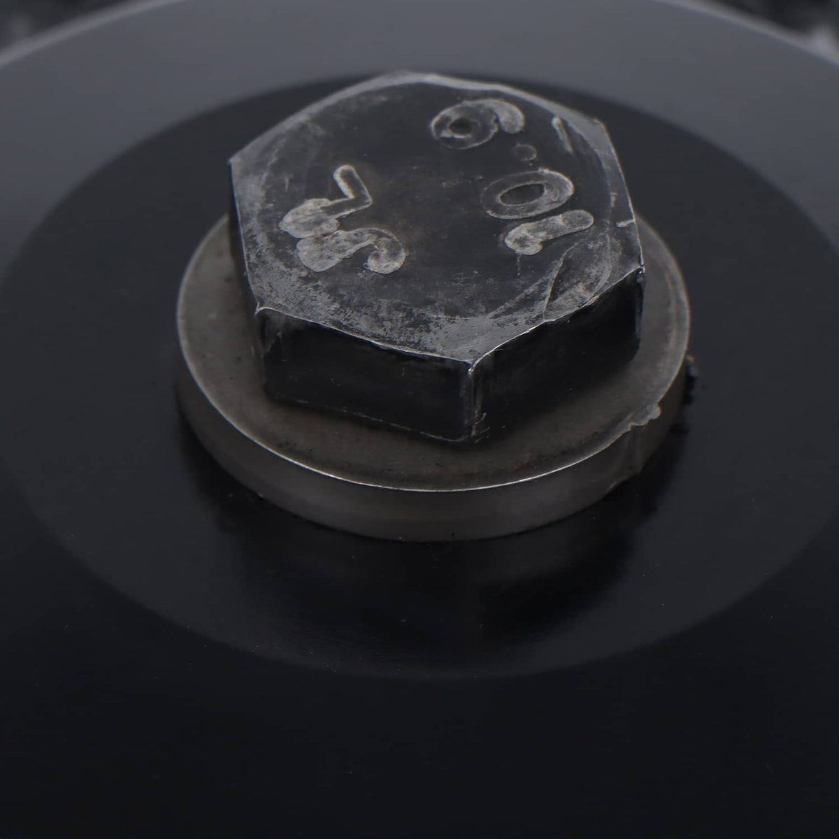 Drive pulley clutch primary assembly close-up of black center cap with stamped markings