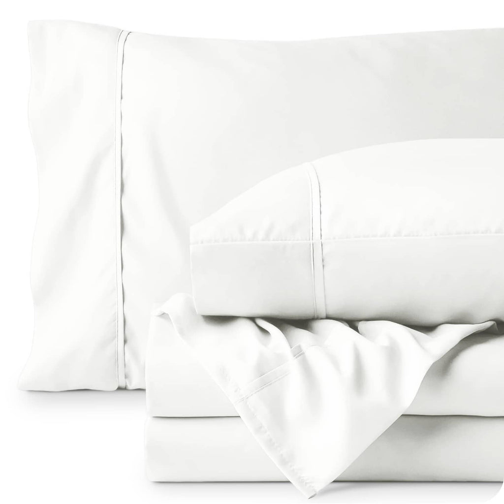 Close-up of cream pillowcases and fitted sheet seams with smooth fabric finish