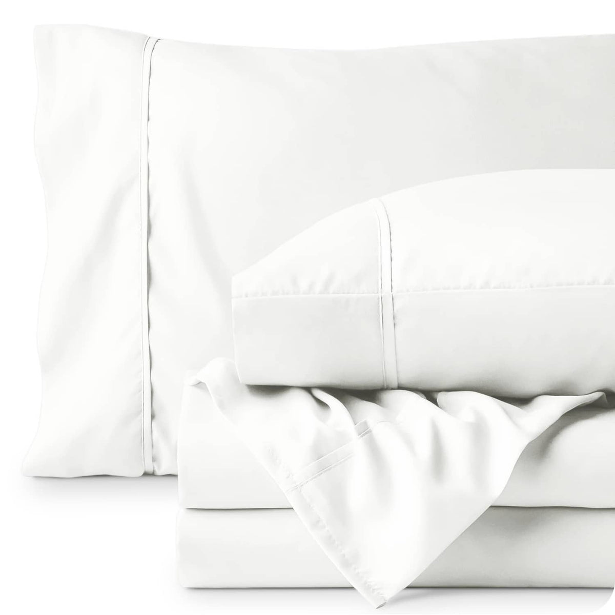 Close-up of cream pillowcases and fitted sheet seams with smooth fabric finish
