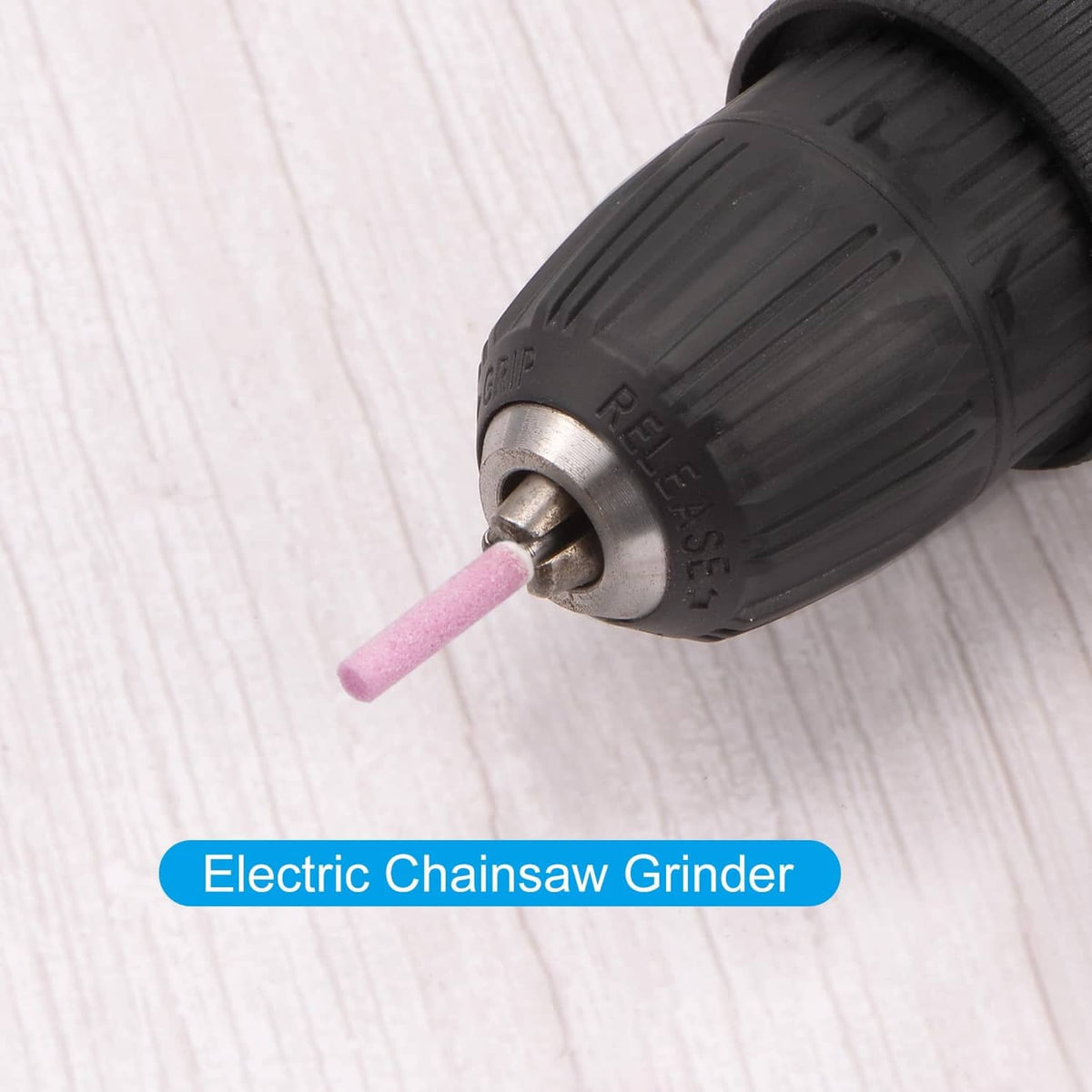 Diamond chainsaw sharpener bit held in electric grinder chuck, pink abrasive tip
