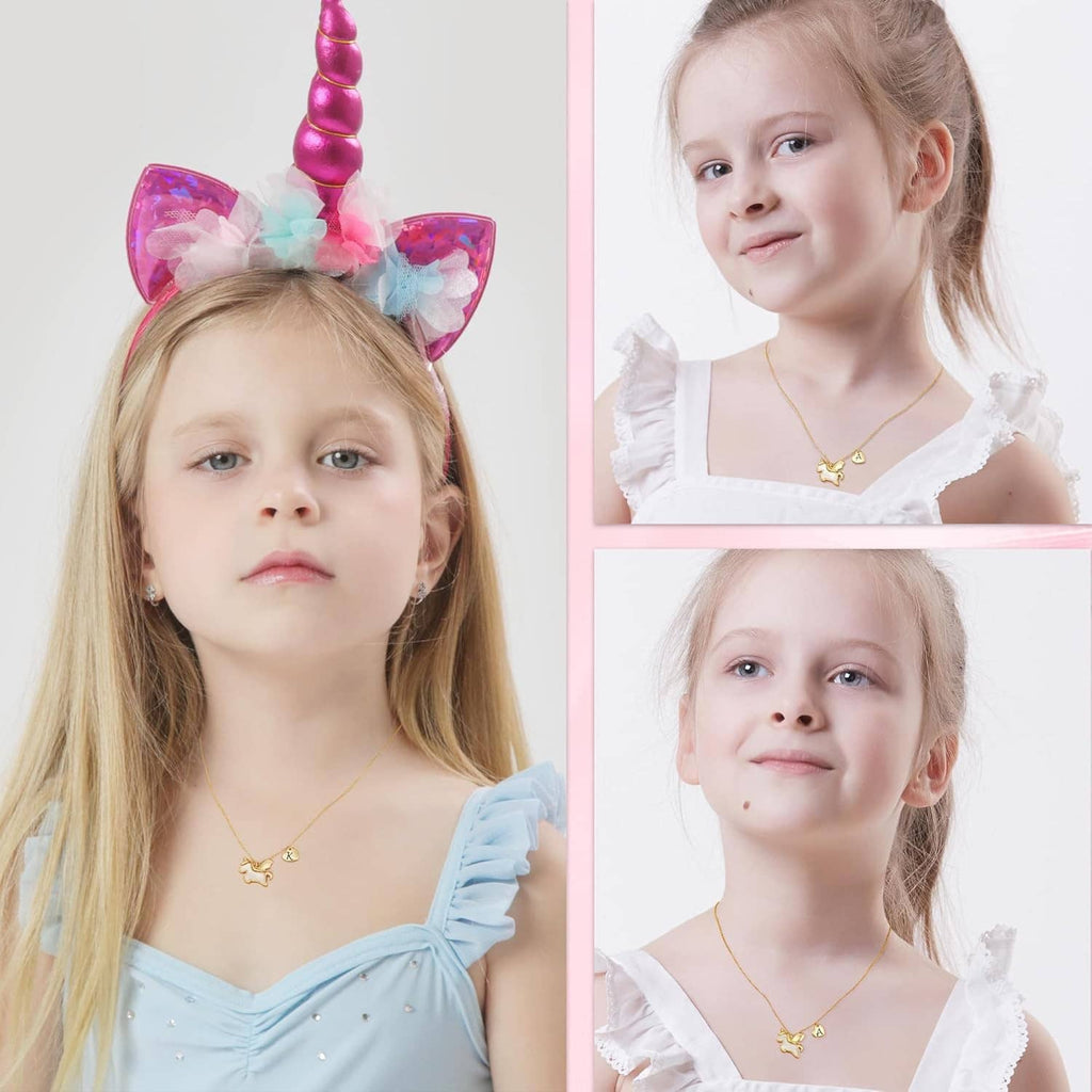 Unicorn pendant necklace with small heart initial charm, worn by a young girl.