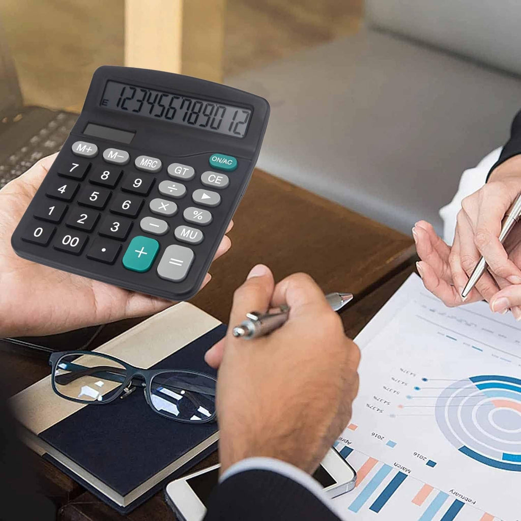 Black desk calculator in use with large LCD display and numeric keypad