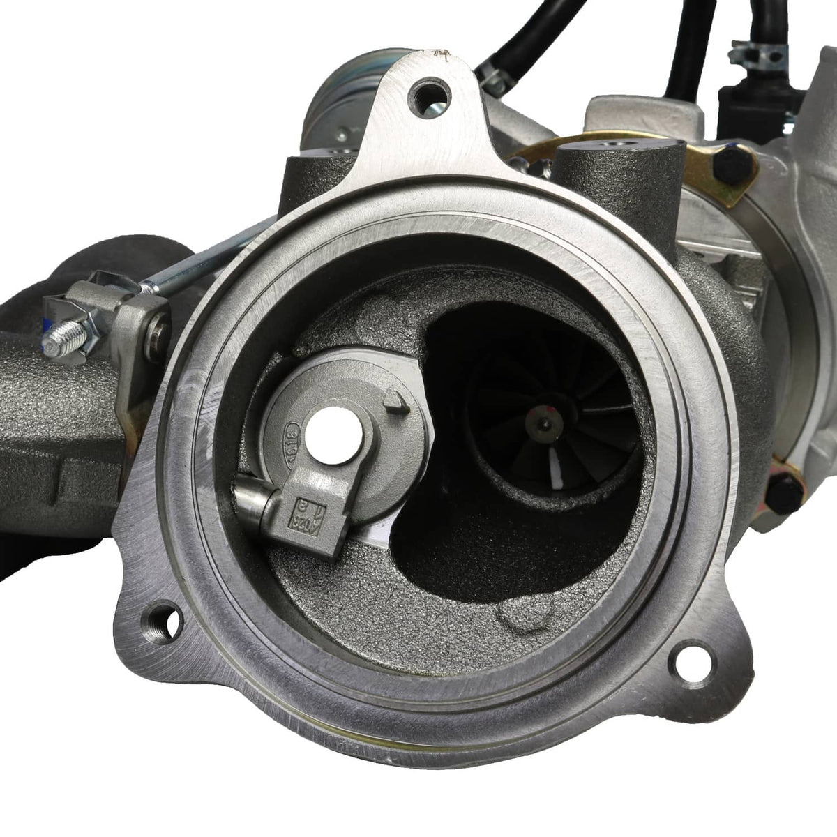Close-up turbocharger compressor inlet with circular housing and mounting bolt holes.