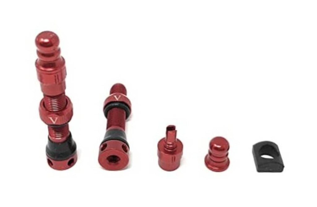 Red tubeless Schrader valve set with integrated core removal tool, caps, and grommet pieces