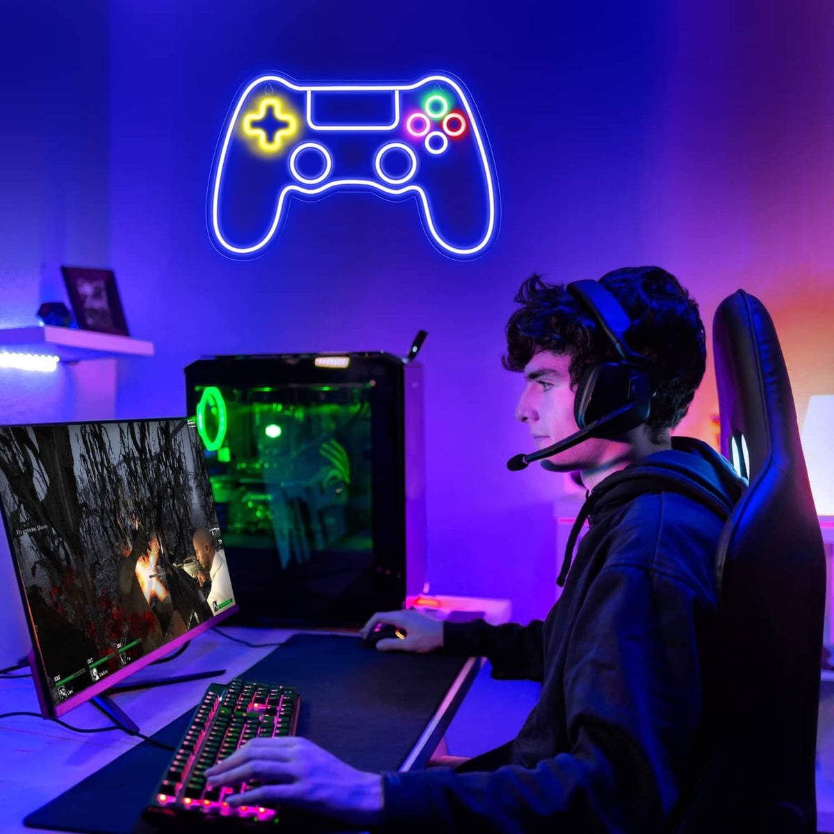 Gaming controller LED neon sign glowing above a gaming setup with headset and keyboard.