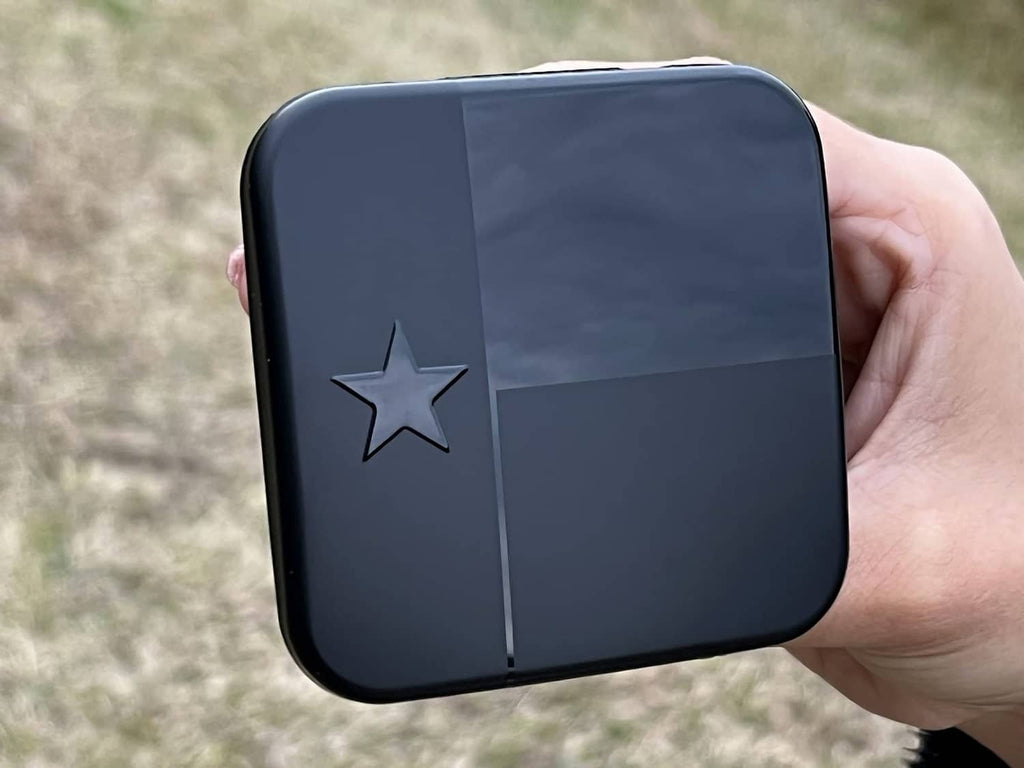 Black square hitch receiver cover with Texas star emblem centered on front.