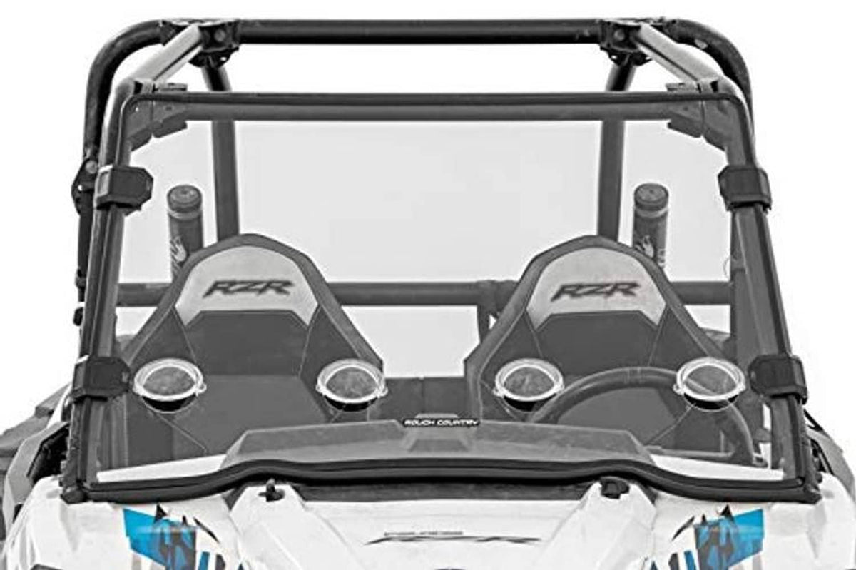 Front windshield installed on UTV with black frame and side mounting blocks