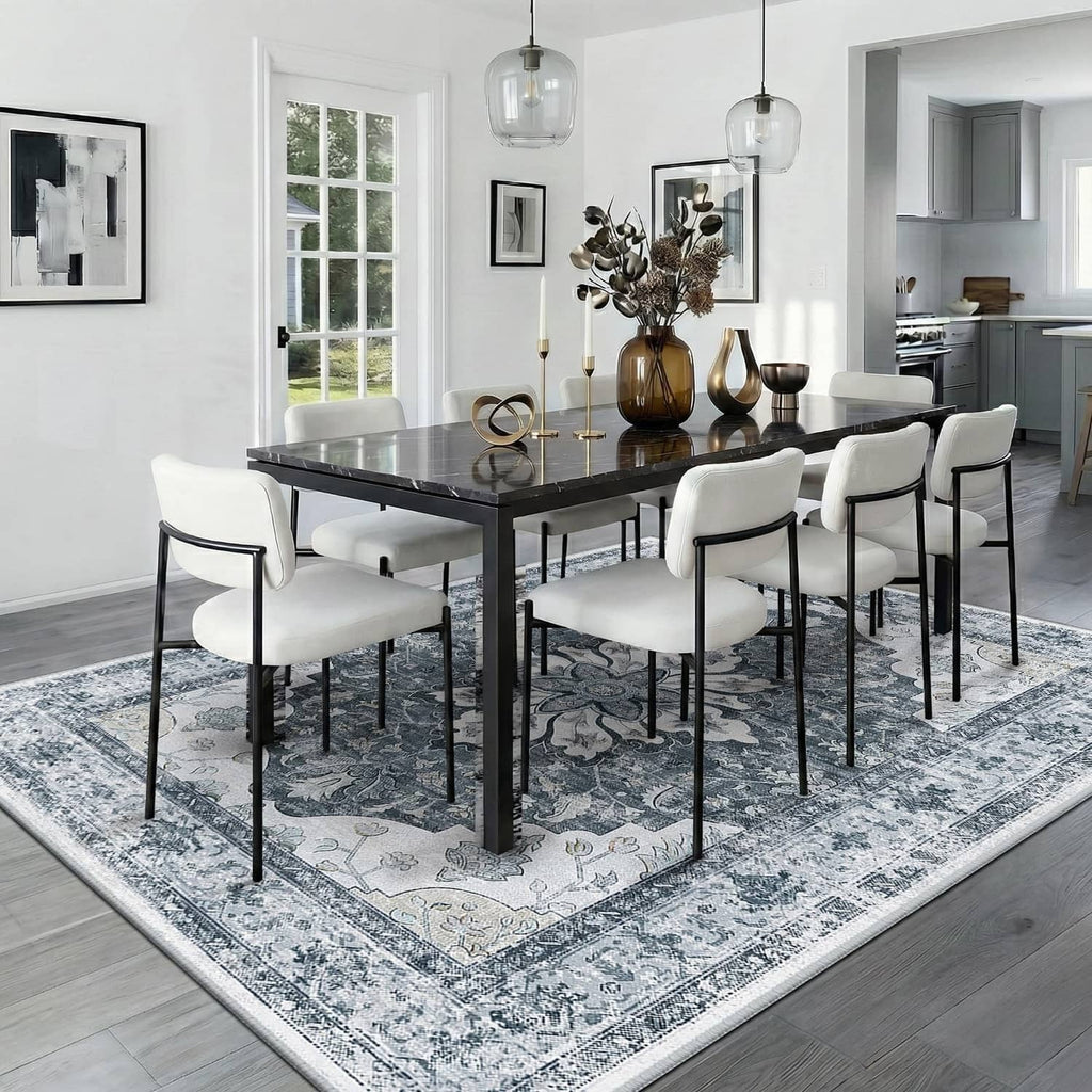 Blue-gray ornate area rug under a dining table with chairs