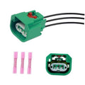 Green headlight wiring harness connector plug with black wire leads and terminal insert