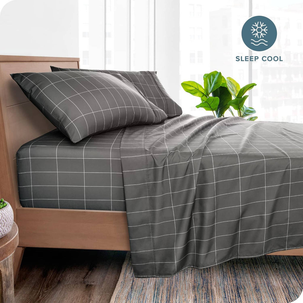 Grey bed sheet set with white check grid print on a neatly made bed
