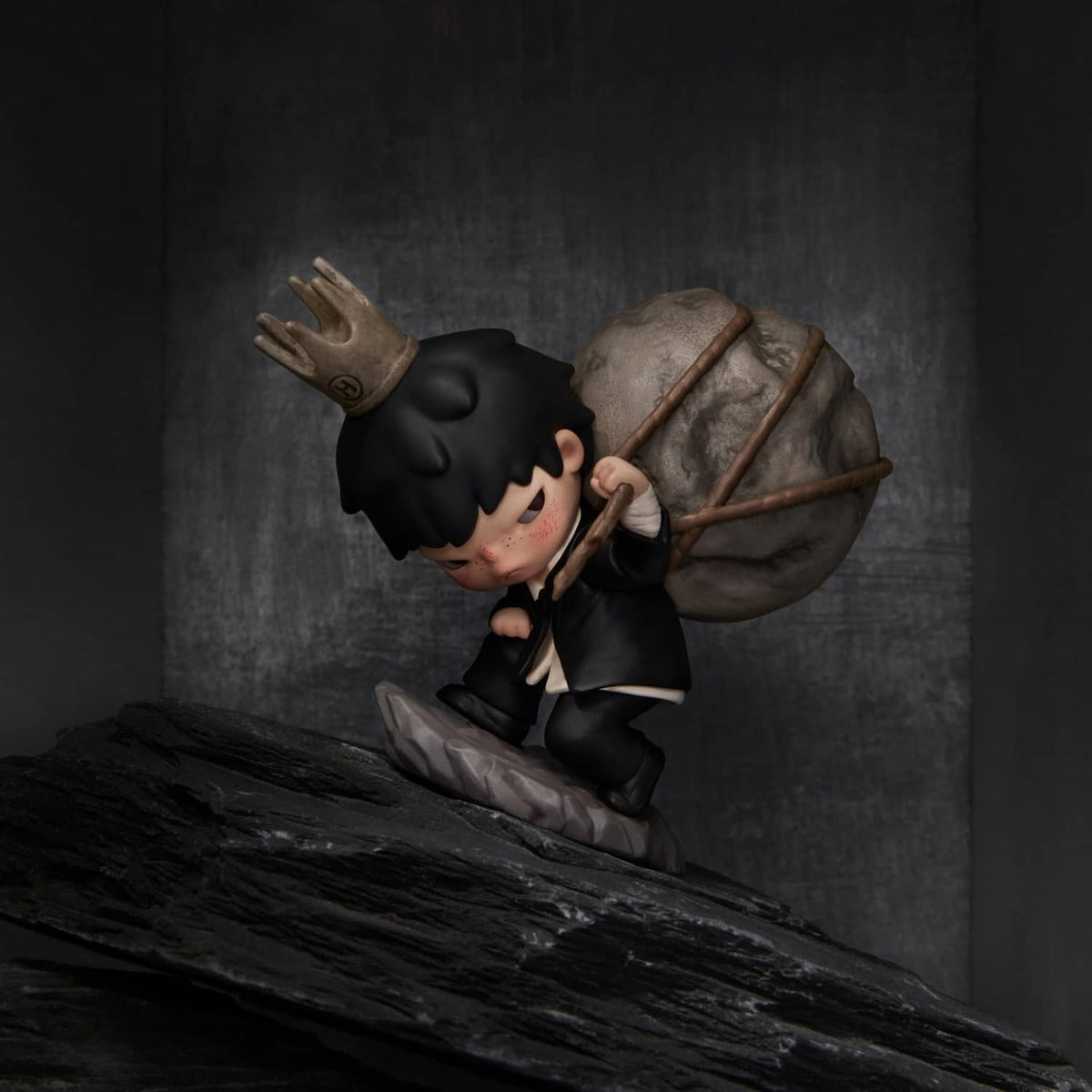 Tamed Hirono figure in a black mask, dark outfit, and carrying a large bag