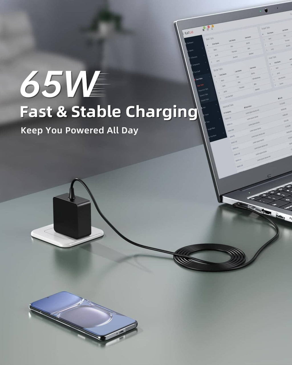 Black 65W laptop charger connected to a laptop and phone via cable