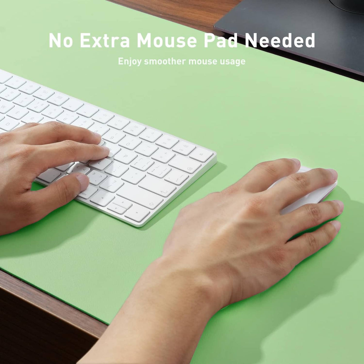 Foam green desk pad protector being smoothed flat on a wooden desk