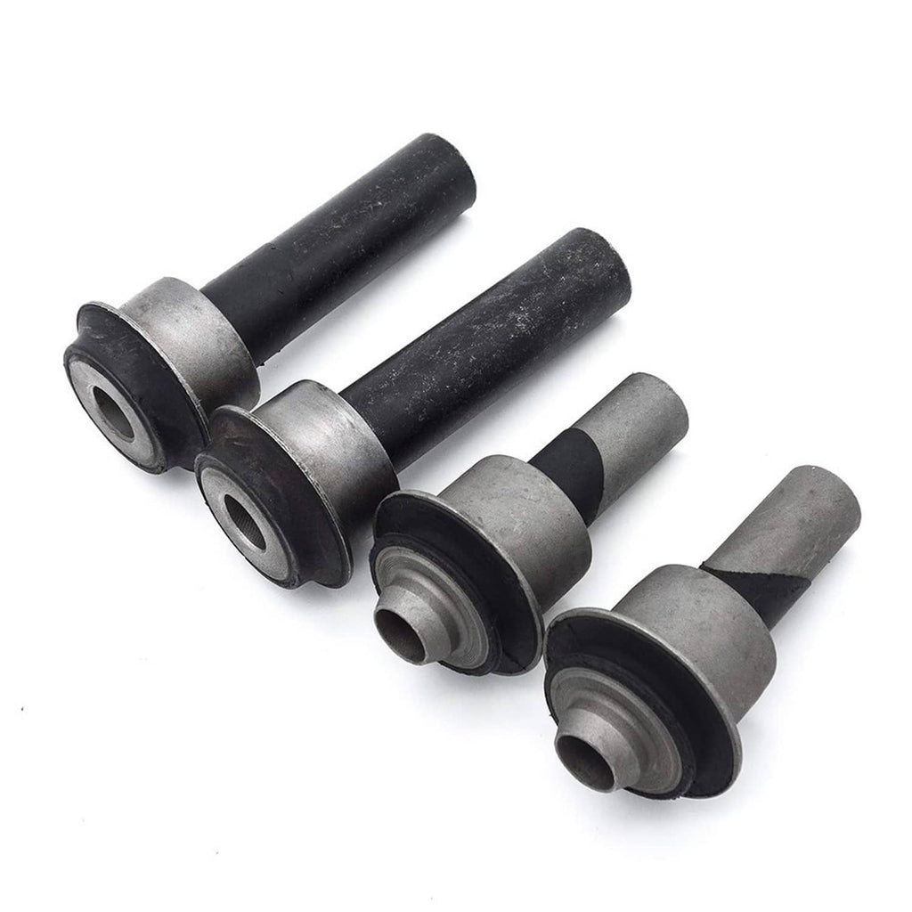 Four front subframe bushings with dark rubber centers and silver metal housings, angled.
