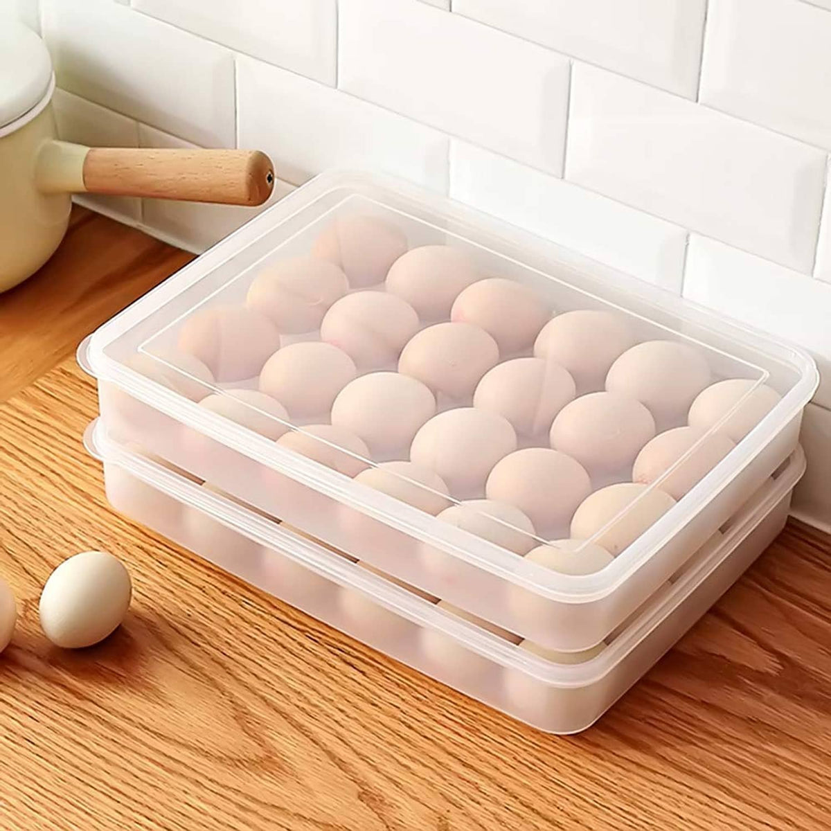 Clear plastic egg tray carrier with lid, holding hard-boiled eggs in round wells