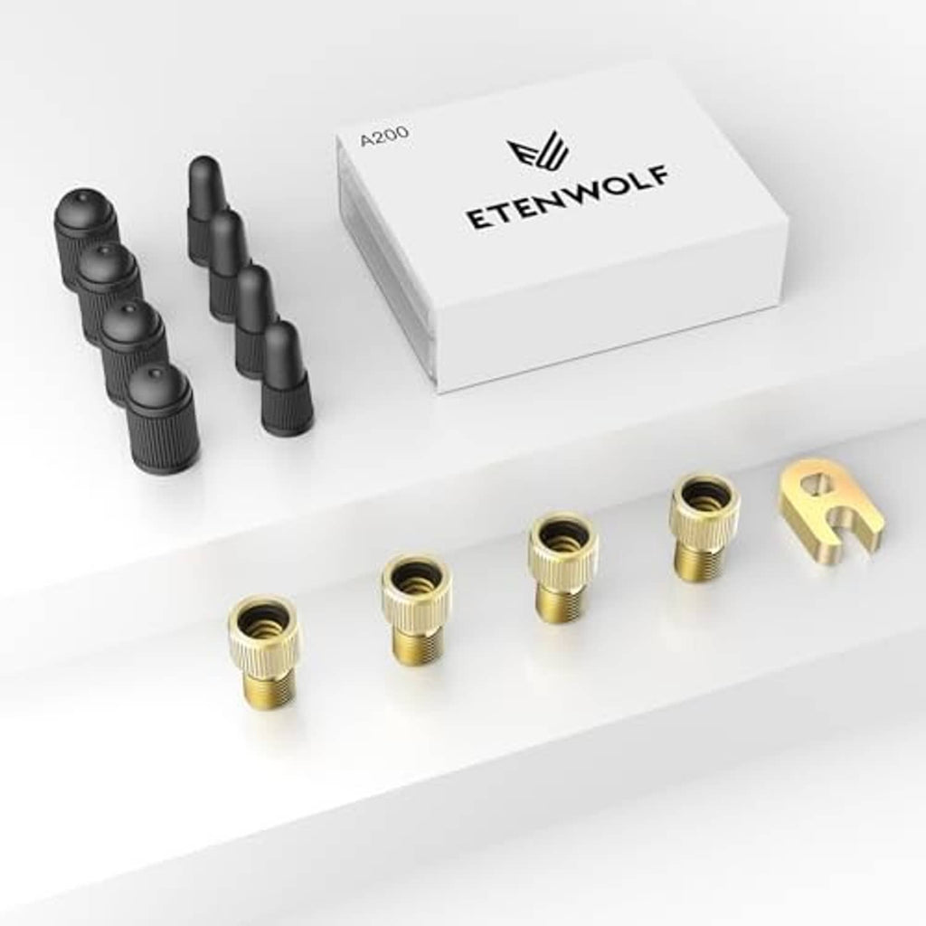 Valve adapter kit: four black-capped adapters, brass pieces, and yellow bracket tool in box.
