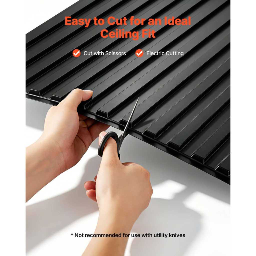 Black linear ridged ceiling tile panel edge being cut by hands