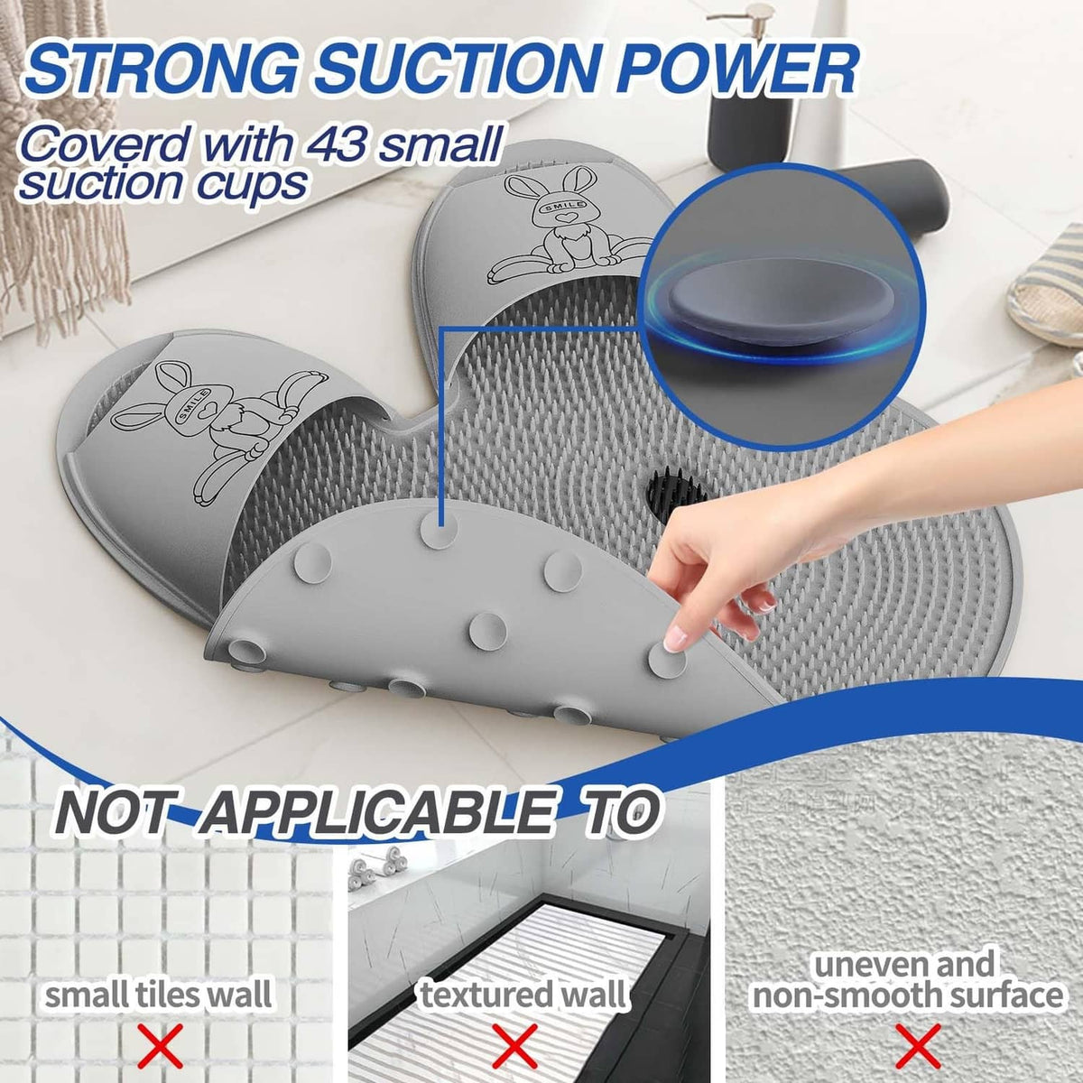 Gray shower foot scrubber mat with suction cups on underside, hand pressing center