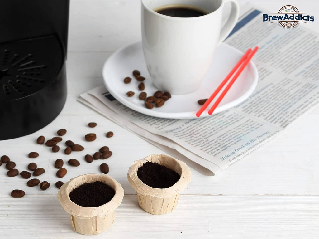 Single-use paper coffee filter filled with dark grounds on a counter