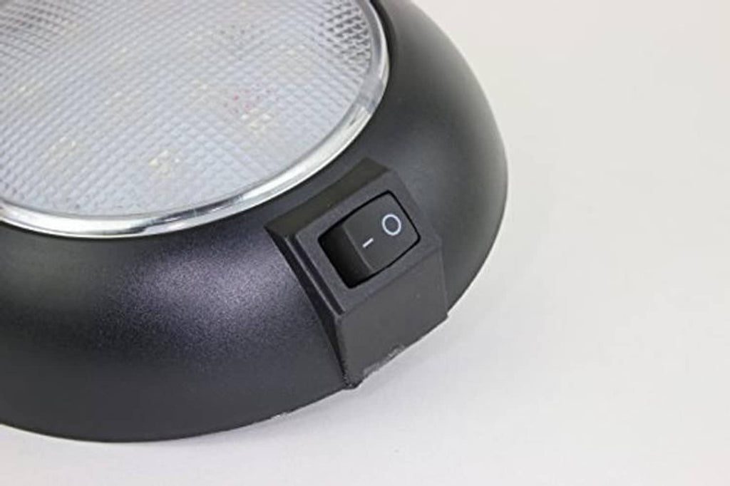 Black dome LED light close-up of side power rocker switch