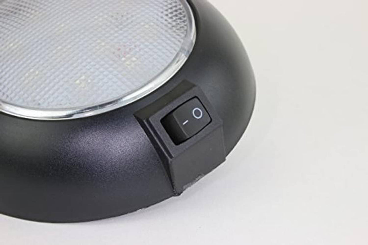 Black dome LED light close-up of side power rocker switch