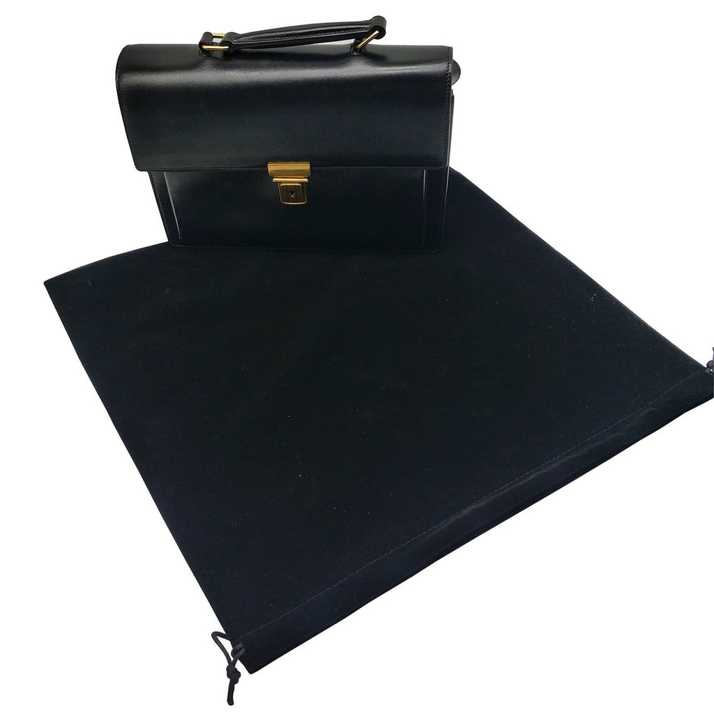Large black velvet drawstring pouch bag laid flat with cord tie ends