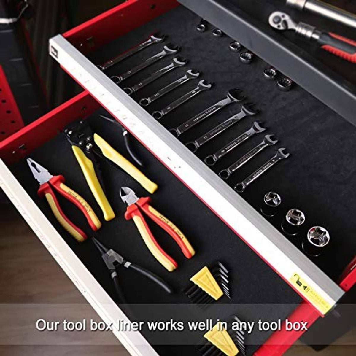 Black tool box liner in open drawer with tools arranged for storage and protection