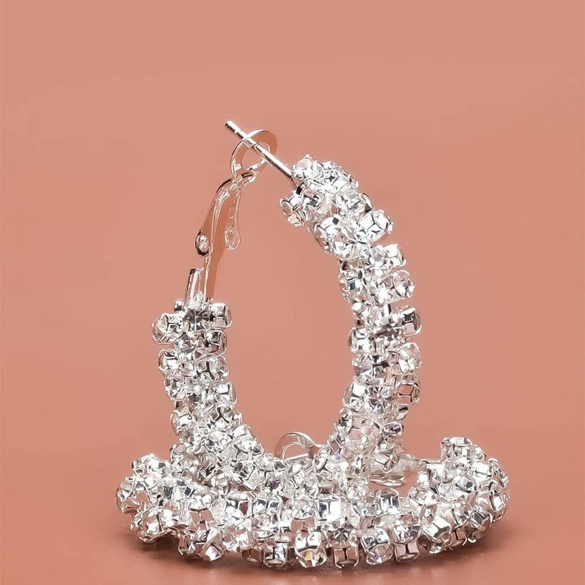 Silver-toned textured hoop earring with densely set sparkling stones and hook back