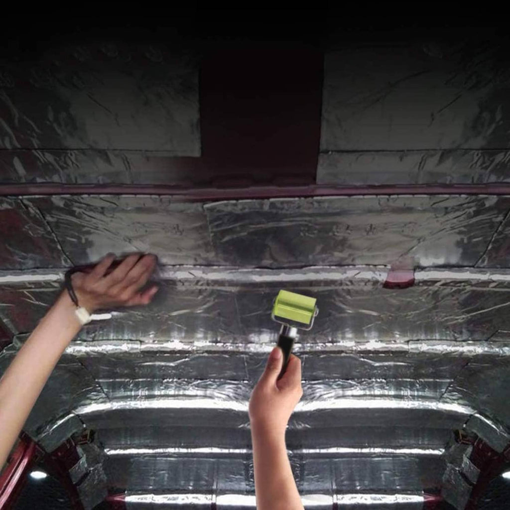 Rubber seam roller applying insulation on metal panels, lime-green wheel