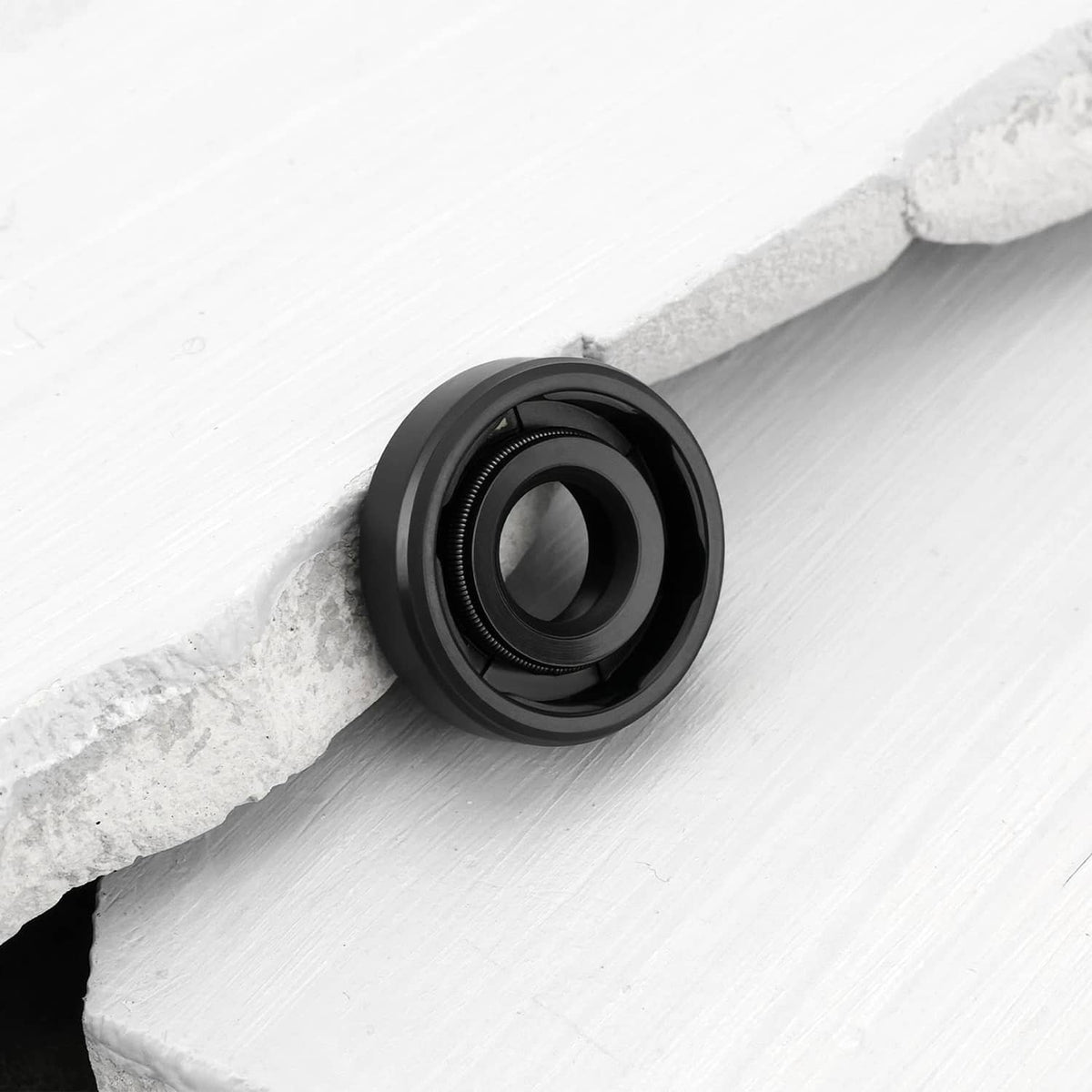 Single black rotary shaft seal with spring lip and circular opening