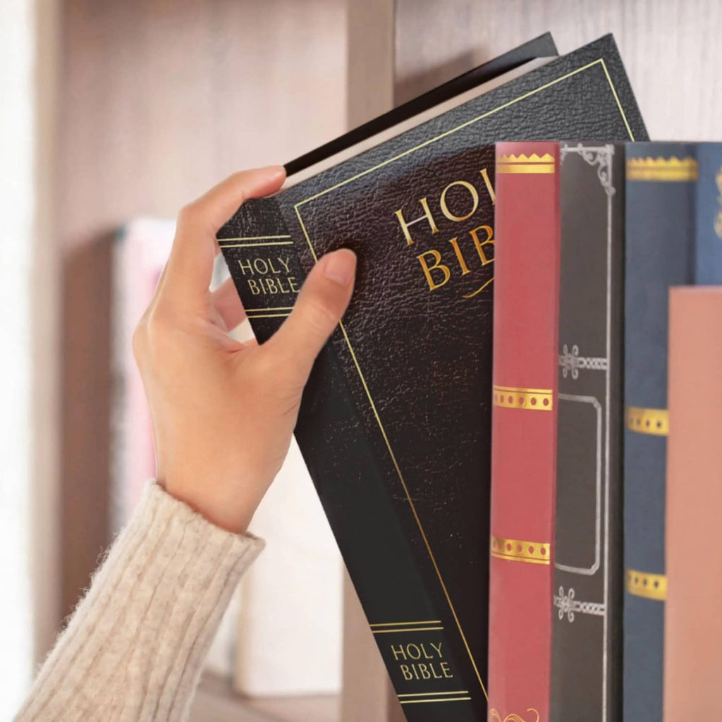 Black book safe with combination lock, held among books