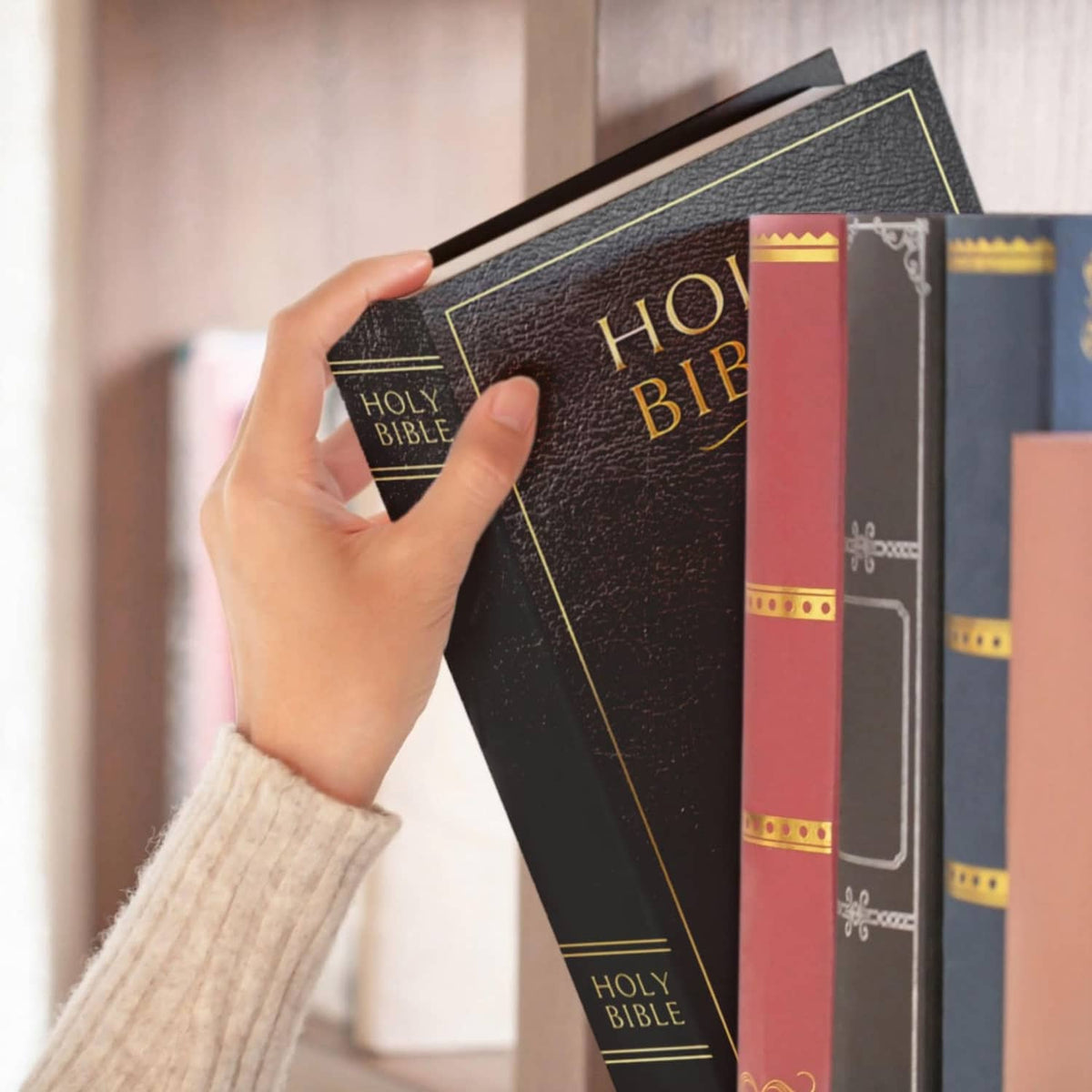 Black book safe with combination lock, held among books
