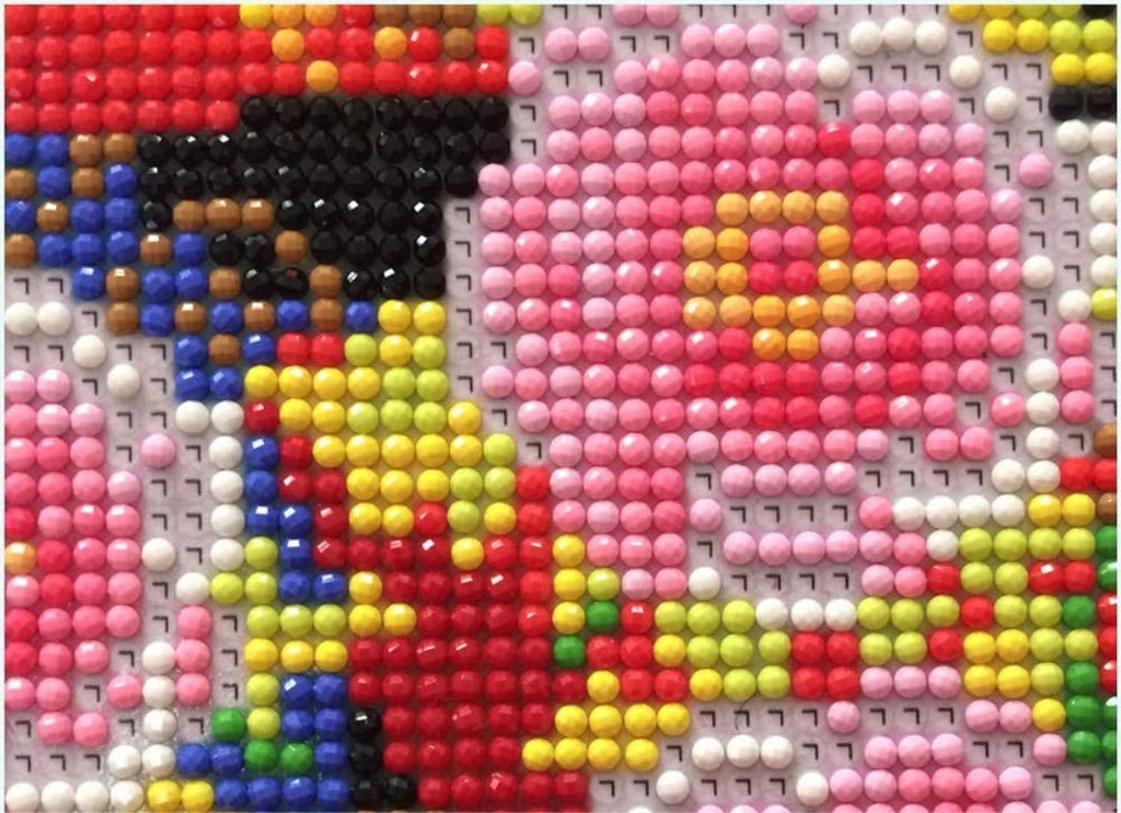 Close-up of multicolor diamond beads on a numbered canvas grid