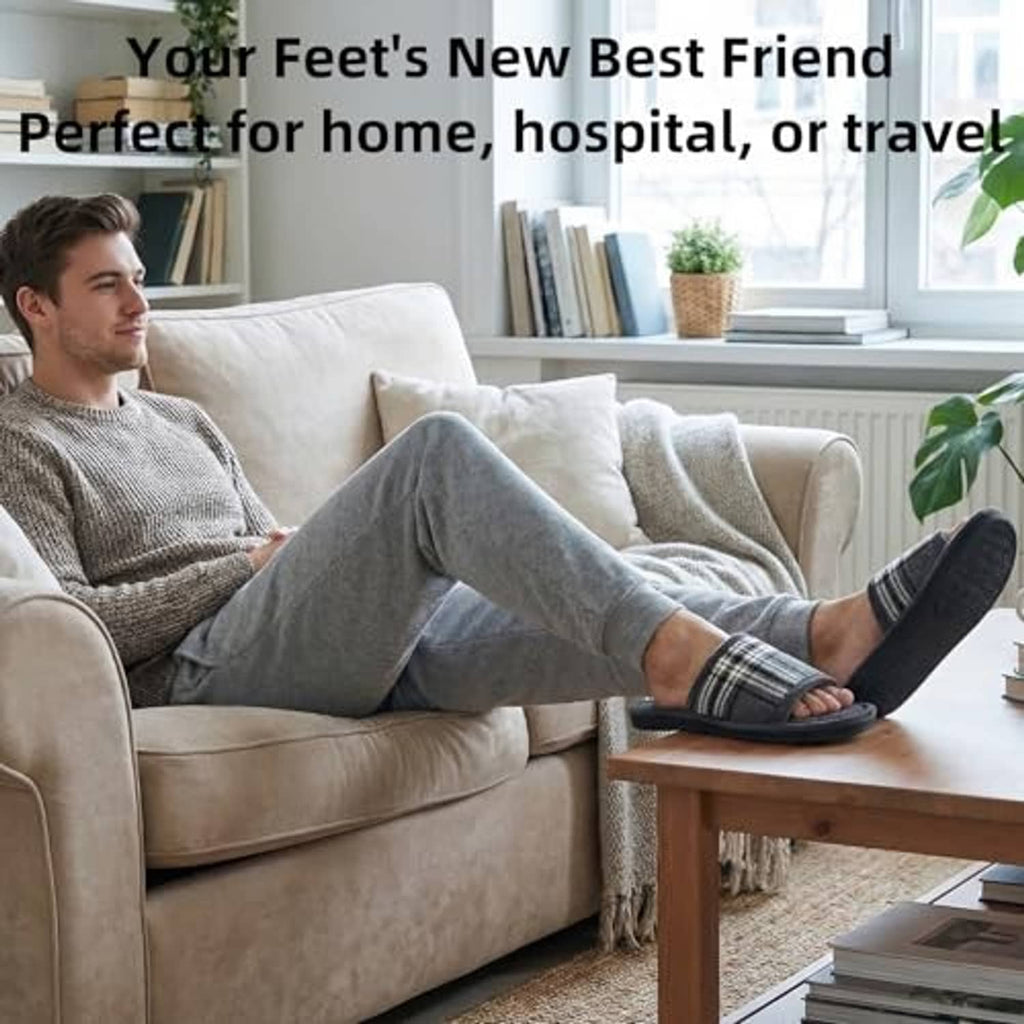 Men's grey plaid open-toe house slippers worn on a couch during indoor lounging