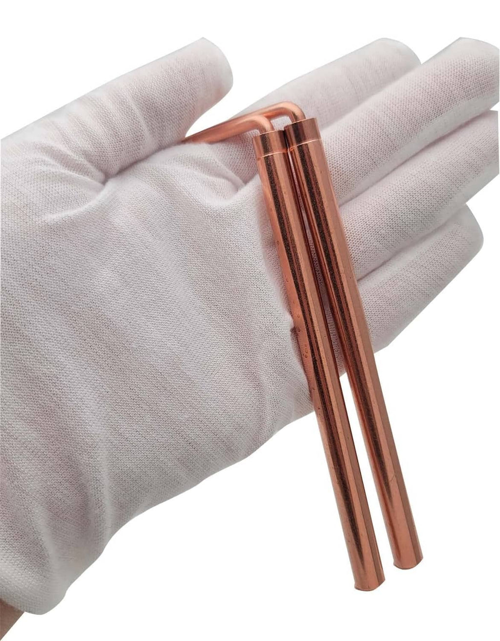 Copper dowsing rods held in a glove, close-up view