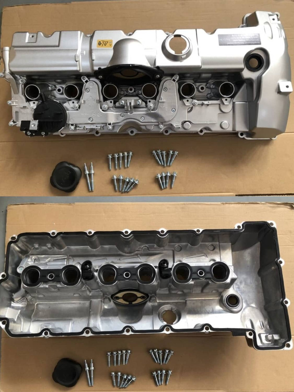 Aluminum valve cover and gasket panel with screws and hardware on cardboard