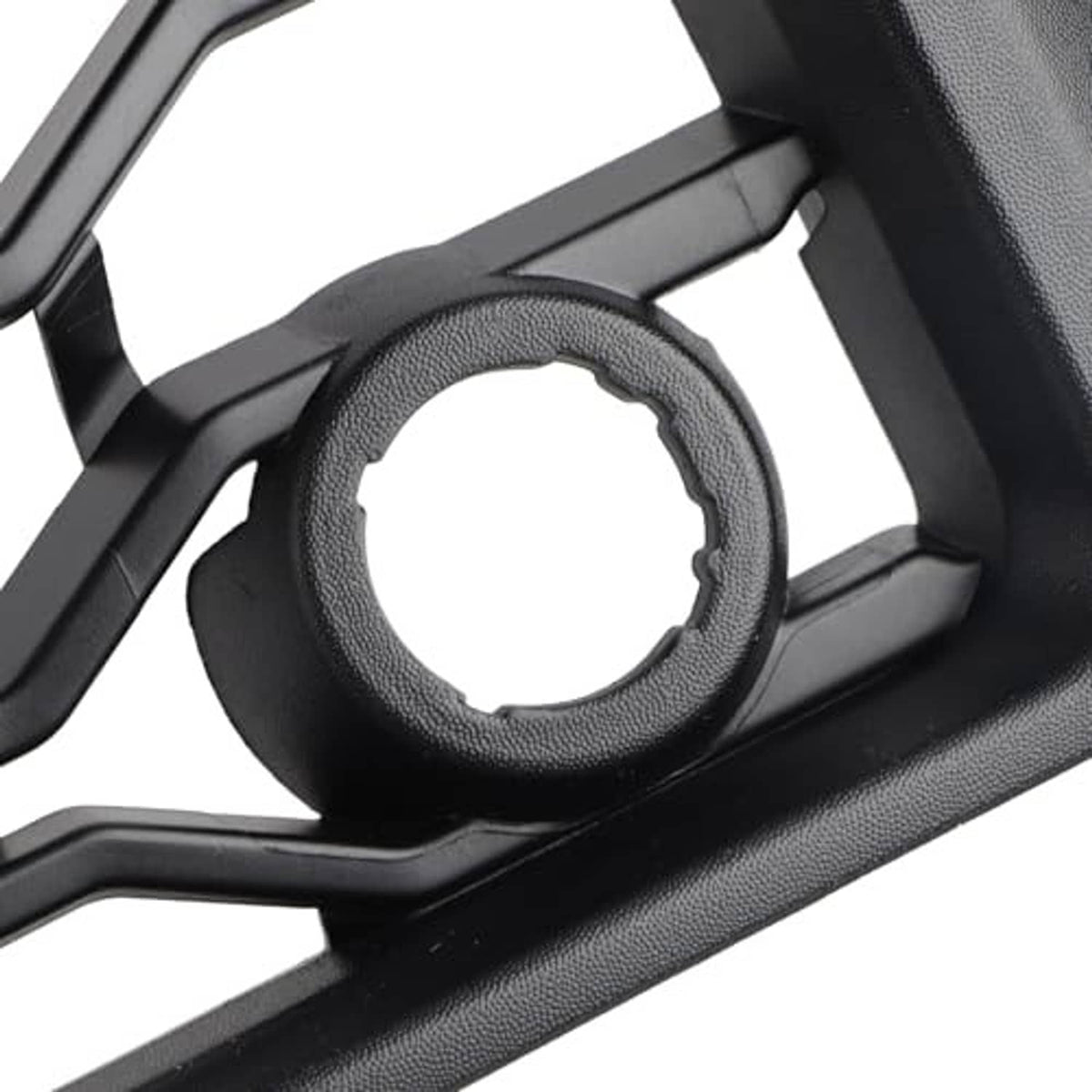 Black grille detail showing circular opening with textured trim ring