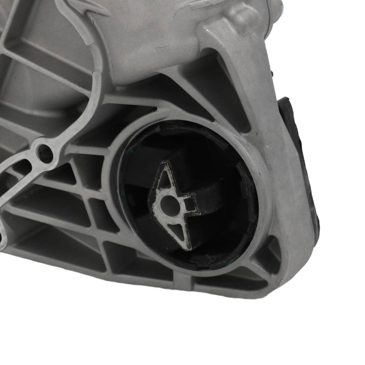 Transfer case assembly close-up of black mount bushing inside gray ribbed casing