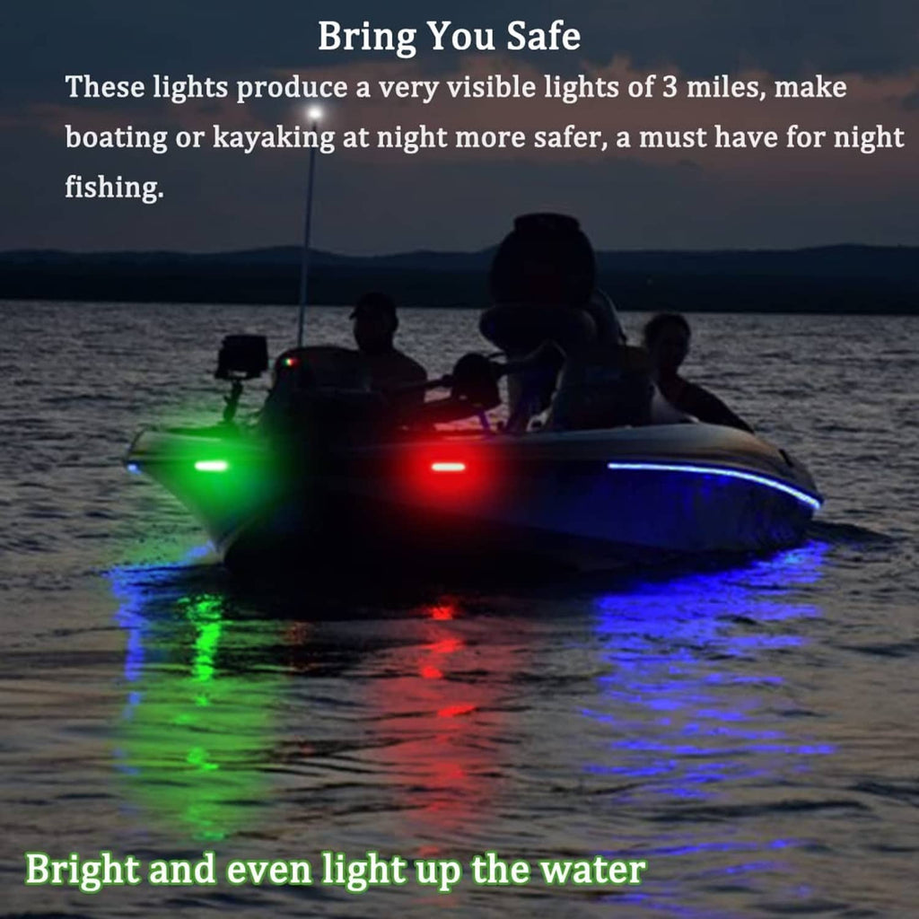 Boat bow navigation lights shining green and red on dark water at night