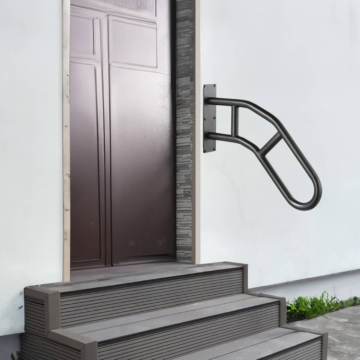 Wall-mounted handrail beside front steps with curved matte black grip