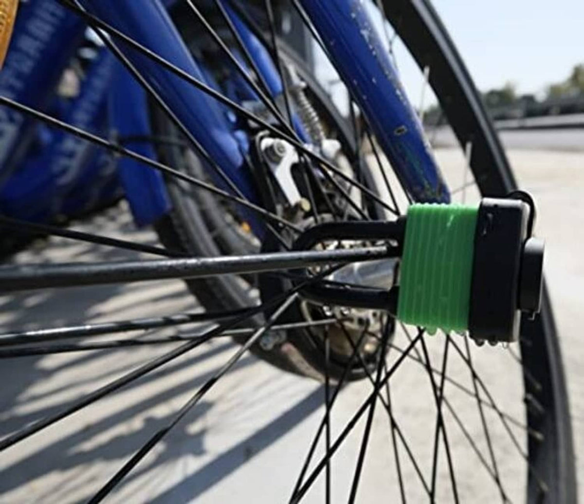Green waterproof U-buckle padlock securing a bicycle wheel and frame