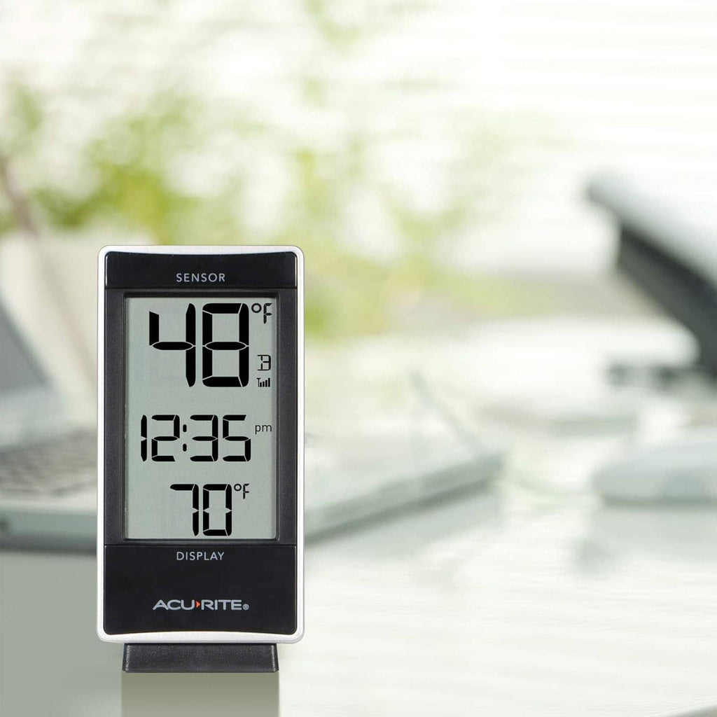 White digital thermometer display showing temperature and time readings