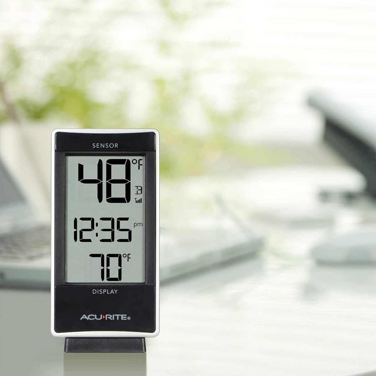 White digital thermometer display showing temperature and time readings