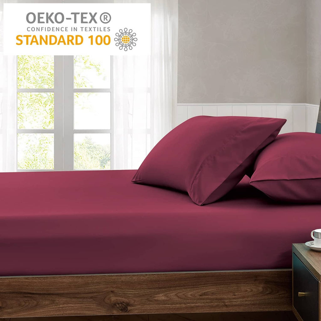 Burgundy queen fitted sheet on bed with matching pillows
