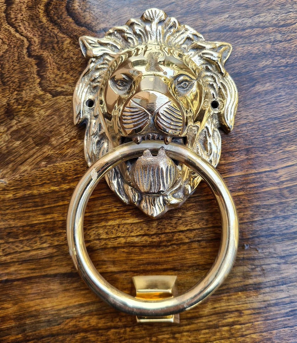 Polished brass lion door knocker featuring a circular ring and lion-face centerpiece