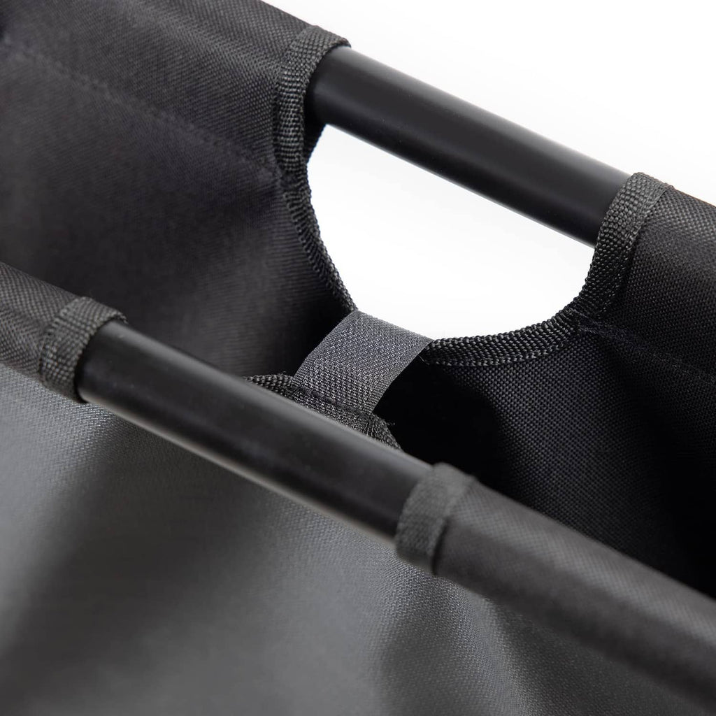 Close-up of black canvas fabric attached to metal tube frame on print rack