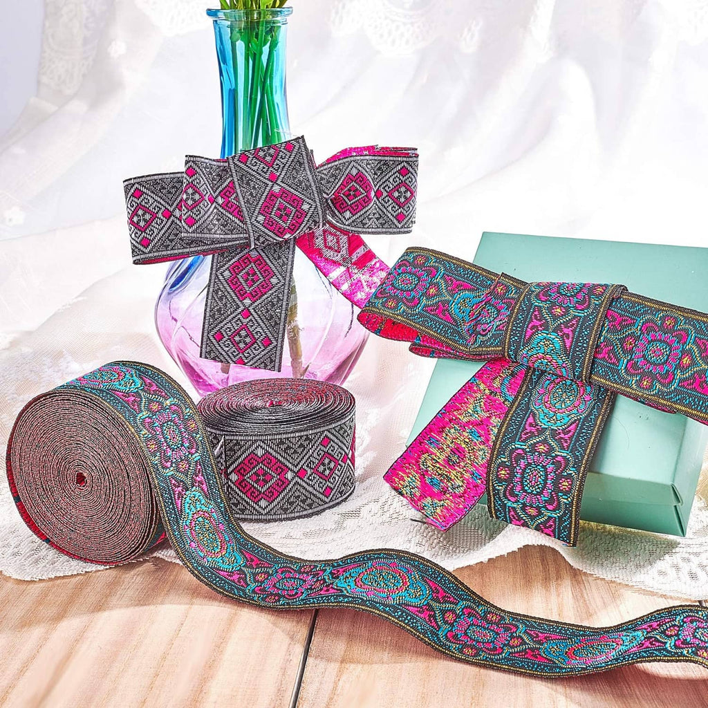 Embroidered jacquard ribbon with repeating floral motifs in teal, magenta, and black